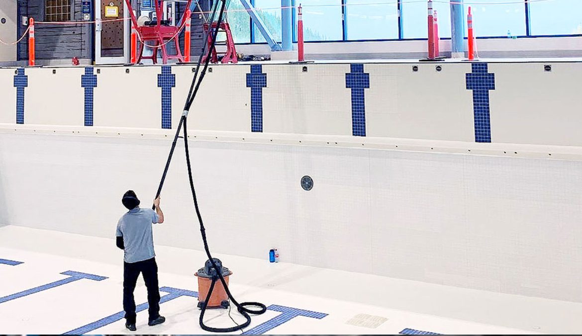 Commercial High Dusting in Whitehorse Commercial high dusting technician cleaning elevated surfaces in a Whitehorse recreation facility